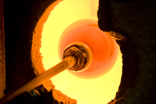 Glass blowing process - softening glass in the kiln.